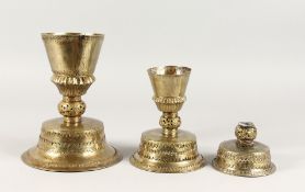 THREE COPPER CANDLESTICKS, POSSIBLY TURKISH. 9ins, 6.5ins and 5.5ins high.