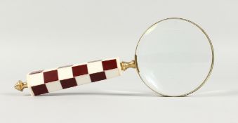 A MAGNIFYING GLASS WITH CHEQUERED HANDLE.