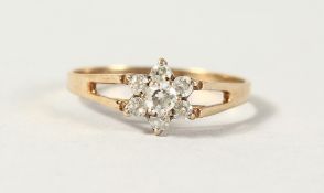 A 9CT GOLD DIAMOND FLOWER CLUSTER RING.