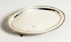 AN OVAL SILVER BEAD EDGE TEAPOT STAND. 7ins wide. Birmingham 1946.