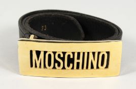 A MOSCHINO ITALIAN BLACK LEATHER AND GILT NAME BELT. 32ins long.