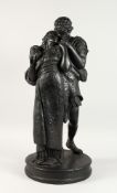 A LARGE LATE 19TH CENTURY/EARLY 20TH CENTURY BLACK PAINTED PLASTER GROUP, young lovers in an