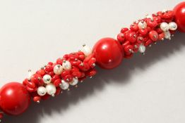 A SILVER, CORAL AND PEARL BRACELET.