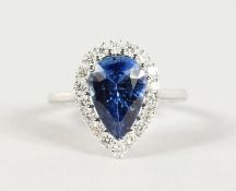 A SUPERB 18CT WHITE GOLD, PEAR SHAPED SAPPHIRE (4CTS) AND DIAMOND RING.