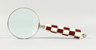 A MAGNIFYING GLASS WITH CHEQUERED HANDLE.