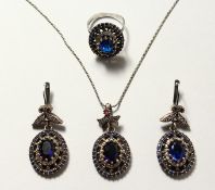 A SILVER AND GOLD PLATED FAUX SAPPHIRE THREE PIECE SET.
