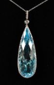 A GOOD 18CT WHITE GOLD, BLUE TOPAZ AND DIAMOND PENDANT on a chain.