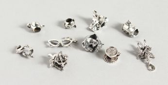 TEN VARIOUS SILVER CHARMS.