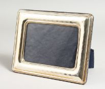 A PLAIN SILVER UPRIGHT PHOTOGRAPH FRAME. 7ins x 5ins.