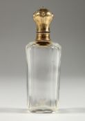 A GLASS GOLD TOP SCENT BOTTLE AND STOPPER. 9.5cms long.