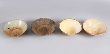 A LOT OF FOUR EARLY CHINESE POTTERY BOWLS, some glazed some unglazed. largest: 15.5cm.