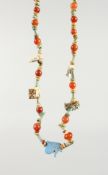 A GLAZED POTTERY AND CARNELIAN AMULET NECKLACE. 16ins long.