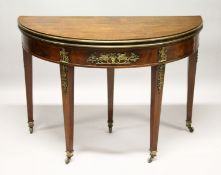 A FRENCH EMPIRE MAHOGANY DEMILUNE FOLD-OVER CARD TABLE, with ormolu mounts, on tapering square