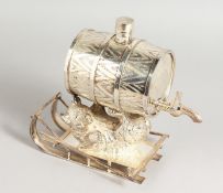 A SILVER PLATE RUSSIAN BEAR DRINKS BARREL on a sledge.