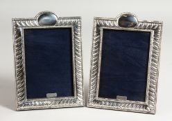 A PAIR OF SILVER SCROLLS AND BEAD DESIGN PHOTOGRAPH FRAMES. 7.5ins x 5.25ins.