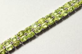 A SILVER DOUBLE ROW PERIDOT LINE BRACELET.