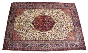 A GOOD PERSIAN CARPET, cream ground with central floral decorated crimson ground panel, the main