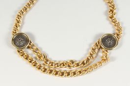 A GILT METAL BELT with two lion masks.