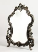 A GOOD, LARGE, SILVER PLATED EASEL MIRROR, rococo style, mounted with cherubs. 24ins high x 17ins