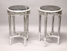 A PAIR OF ROUND SILVERED WOOD TABLES with marble tops.