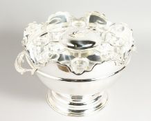 A SILVER PLATED CIRCULAR CAVIAR SET with eight glass tumblers. 12ins diameter.