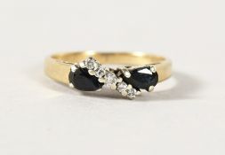 A 9CT GOLD CROSSOVER RING.