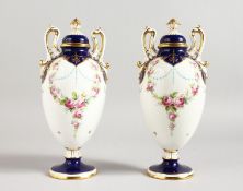 AN EARLY 20TH CENTURY MINTON PAIR OF TWO-HANDLED PEDESTAL OVOID VASES painted by Dudley, signed,