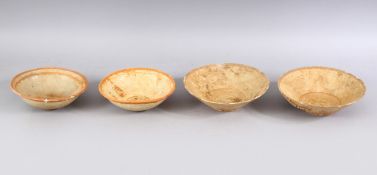 A LOT OF FOUR EARLY CHINESE POTTERY BOWLS, some glazed some unglazed. largest: 18cm diameter.