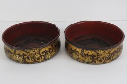 A delightful pair of late 19th century papier mache and gilded wine coasters, each 13.5cm dia.