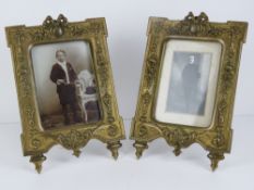 A pair of French ornate cast brass photograph frames with swag, bow,