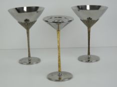 Stuart Devlin: a pair of cocktail / Martini glasses (vessels) having the classic gold plated relief