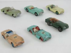 Three Dinky Toys Triumph TR2 cars, together with another (tyres deficient), a Corgi Triumph TR3,