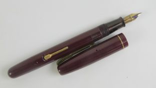 A vintage Watermans 'self-filler' fountain pen with original 14ct gold nib.