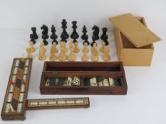 A folding wooden cribbage board inlaid with rosewood and boxwood with bone peg holders,