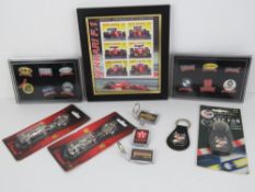 A framed set of Ferrari themed stamps together with two Official Ferrari keychains,