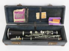 Clarinet: an old French Rosewood clarinet with spare reeds and in a case,