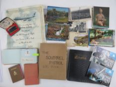 A black and white photograph album, a vintage Girl Guide patrol book,