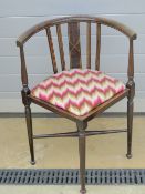 A slender Edwardian corner chair, strung with boxwood, legs united by an X shaped stretcher.