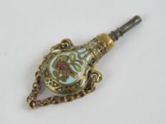 A delightful cloisonné pocket watch winder key in the form of a shooting powder flask and suspended