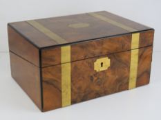 A good late Victorian walnut writing slope, inlaid with brass banding,