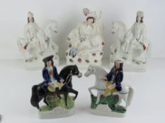 An opposing pair of Staffordshire flat back figurines each being a rider, musket in hand,