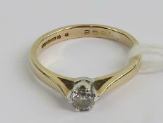 A 9ct gold diamond solitaire ring, the round cut brilliant being 0.