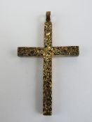 A 9ct gold crucifix having heavy floral engraving, hallmarked 375, 46mm inc bale, 7.9g.