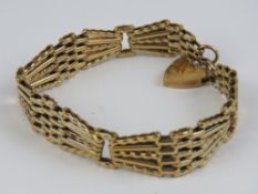A 9ct gold geometric five bar bracelet with heart padlock clasp, hallmarked 375, 21g.