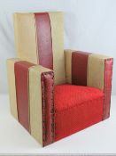 A vintage leatherette child's armchair c1960s having oversprung seat. 66cm high x 52cm wide.