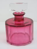 An Art Deco pink glass oversized scent bottle, square shaped stopper, all standing 14cm high.