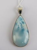 An unusual blue stone pendant of teardrop form, 5.6cm inc white metal bale.