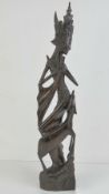 An Indo-Asian rosewood carved and pierced slender statuette, 57cm high.