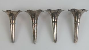 Four silver plated eperne floral spill flutes, each measuring 12cm in length.