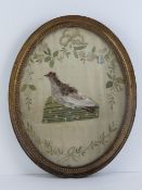 A Georgian needlework oval panel depicting a feathered game bird having real feathers upon,